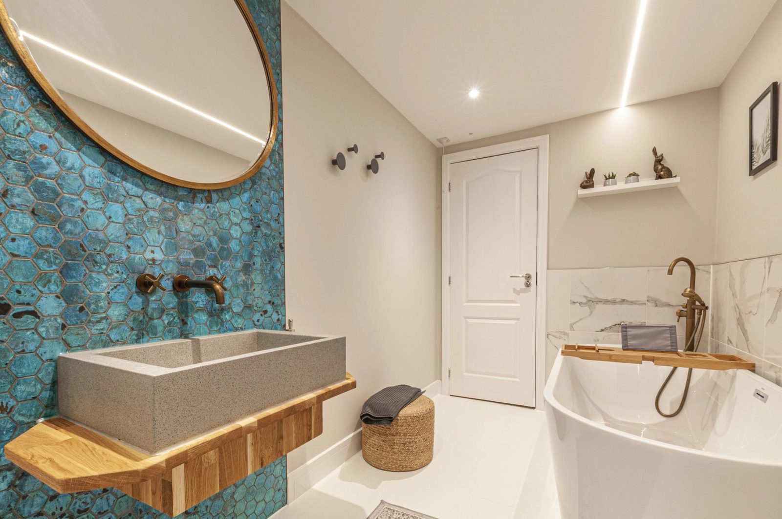 The finished bathroom at Regent Street, a feature wall of blue hexagonal tiles