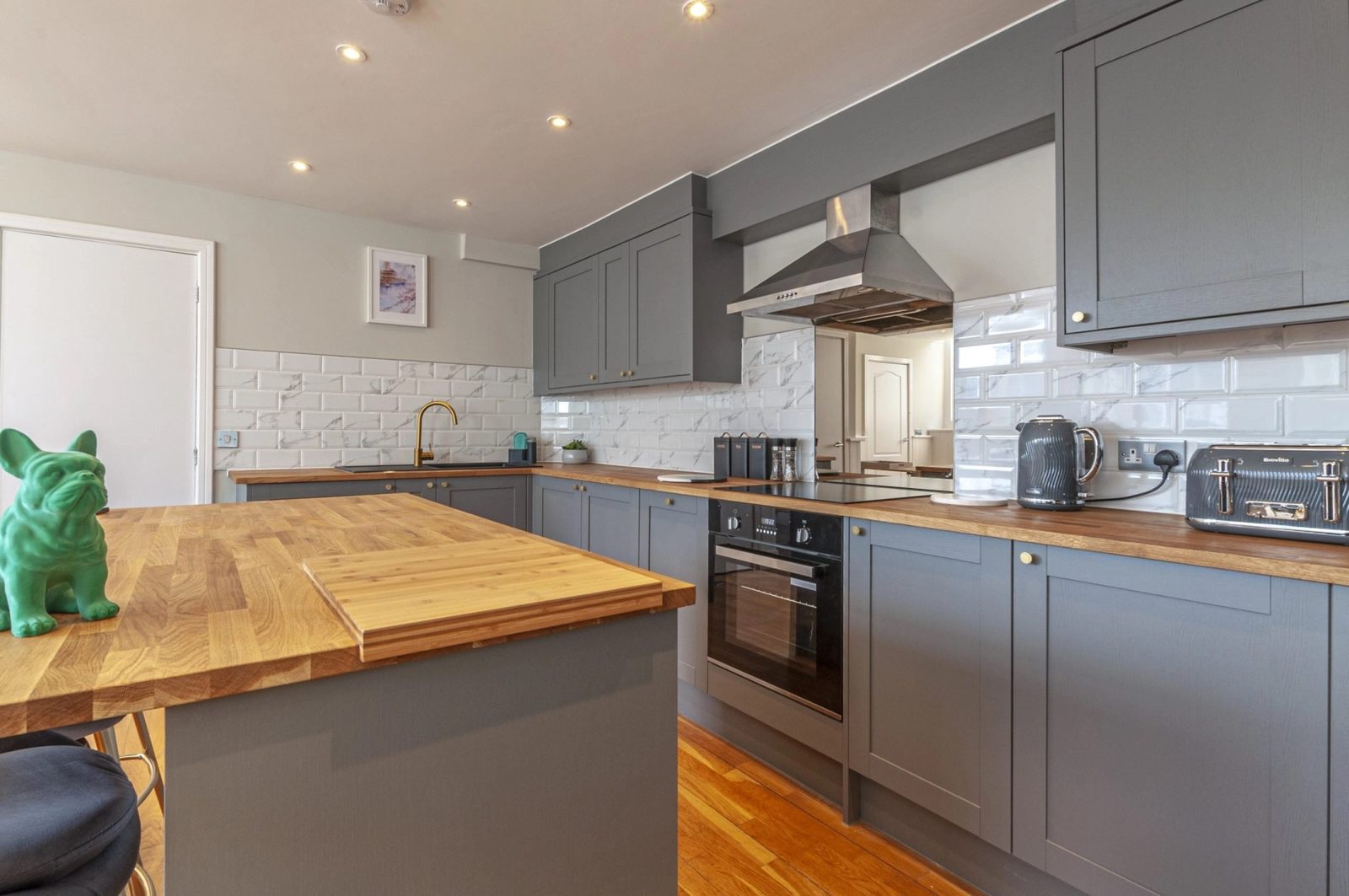 Kitchen with a solid timber worktop and breakfast bar
