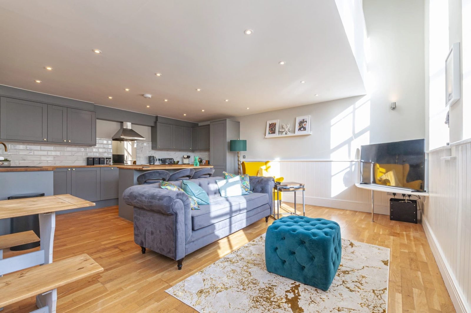 Living area and kitchen across the lower floor